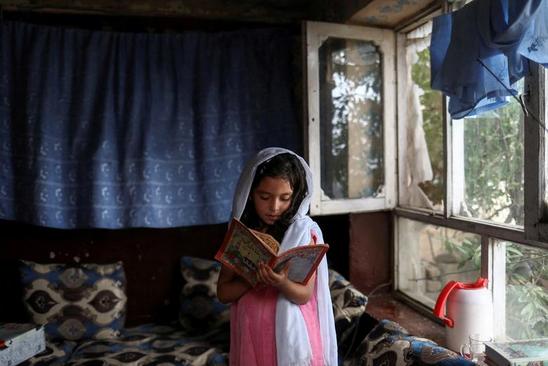 دختر دانش آموز افغانستانی در حال درس خواندن در خانه + عکس